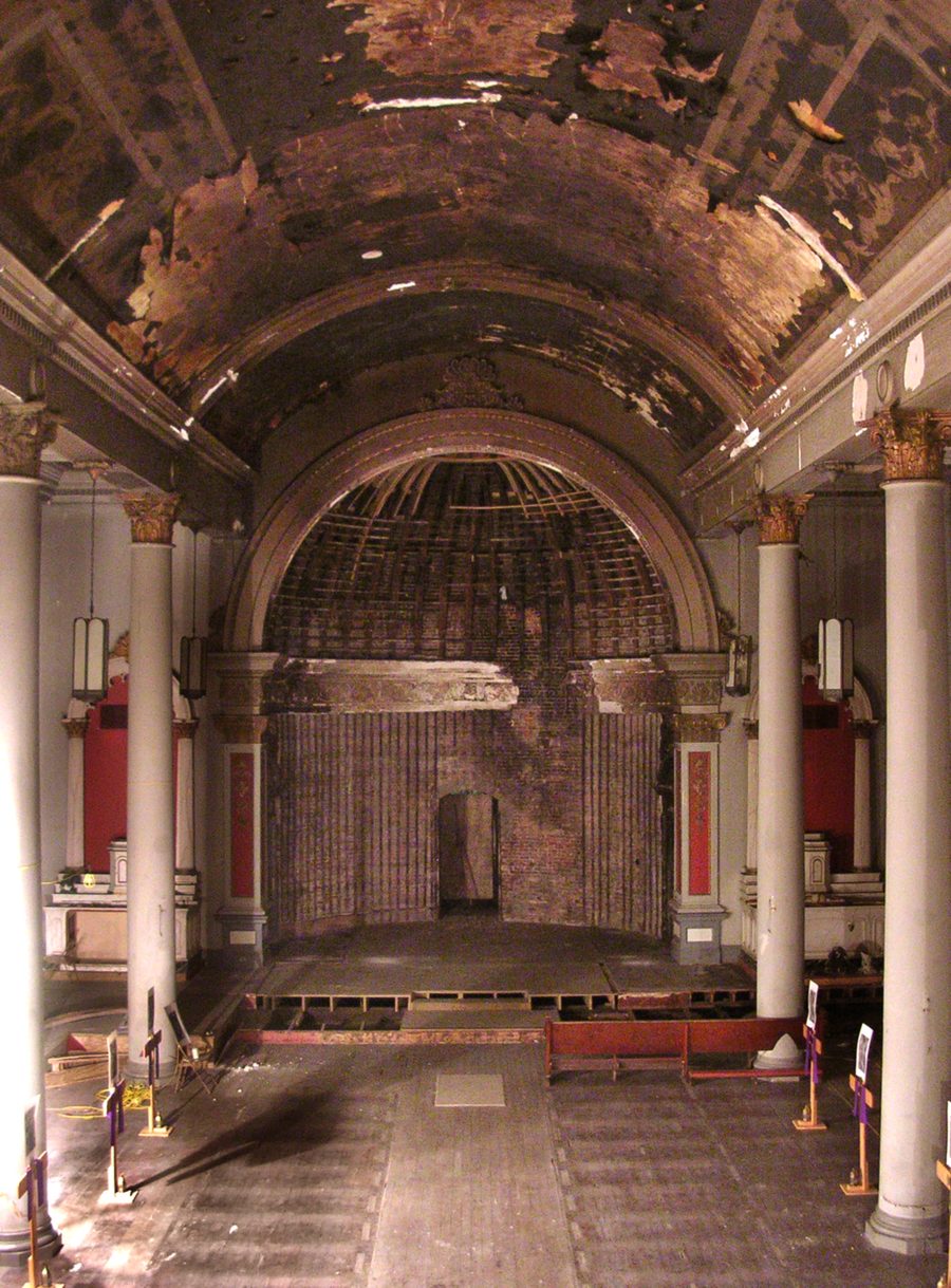 Interior of the church after the May 2003 fire — the charred barrel-vault ceiling and stripped sanctuary